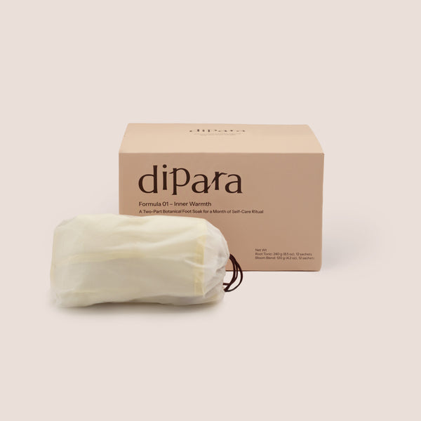Dipara Formula 01 Inner Warmth herbal foot soak box set with a foldable foot basin, presented in a minimalist studio setting.