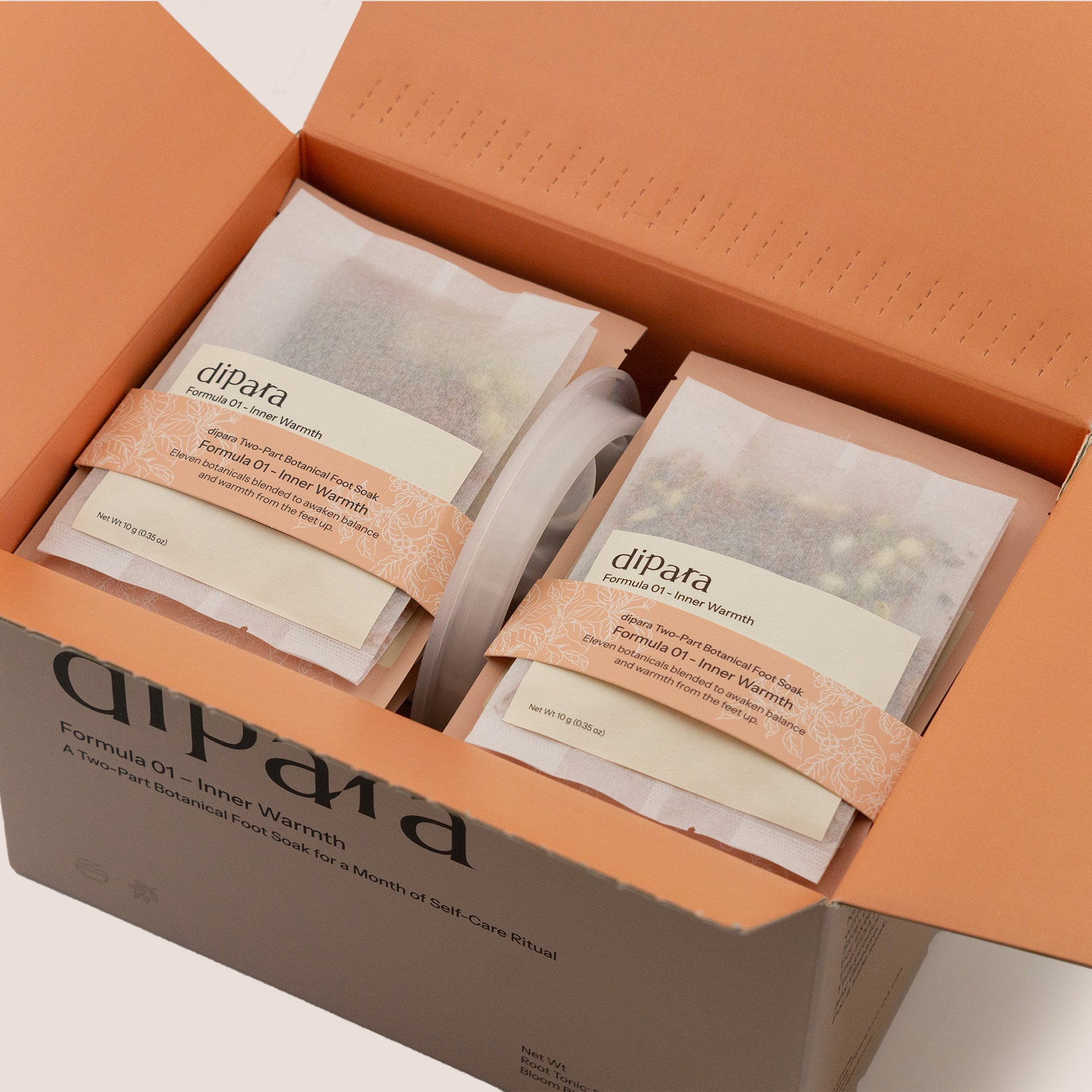 Open Dipara Formula 01 Inner Warmth herbal foot soak box showing individual botanical sachets neatly arranged inside.